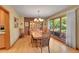Elegant dining room with hardwood floors, large windows, and a stylish chandelier at 8136 S Glencoe Ct, Centennial, CO 80122