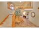 Spacious entryway featuring a staircase with wood railing and tile flooring at 8136 S Glencoe Ct, Centennial, CO 80122