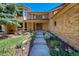 Inviting entrance with stone steps, garden beds, and a solid wood double door at 8136 S Glencoe Ct, Centennial, CO 80122