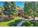 Charming brick home featuring lush landscaping and a curved walkway leading to the front entrance at 8136 S Glencoe Ct, Centennial, CO 80122