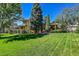 Charming home featuring mature trees and a lush green lawn in a desirable neighborhood at 8136 S Glencoe Ct, Centennial, CO 80122