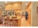 Open-concept kitchen featuring wooden cabinets, granite countertops, and stainless steel appliances at 8136 S Glencoe Ct, Centennial, CO 80122