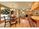 Sunlit eat-in kitchen boasts a dining table, granite counters, and wood floors at 8136 S Glencoe Ct, Centennial, CO 80122