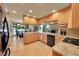 Well-equipped kitchen with custom cabinets, granite countertops, and hardwood floors at 8136 S Glencoe Ct, Centennial, CO 80122