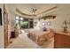 Spacious main bedroom featuring a large window and tray ceiling at 8136 S Glencoe Ct, Centennial, CO 80122