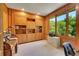 Bright office with custom built-in shelving and large windows overlooking lush greenery at 8136 S Glencoe Ct, Centennial, CO 80122