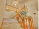 Carpeted staircase with wood railing, leading to the upper level of the home at 8136 S Glencoe Ct, Centennial, CO 80122