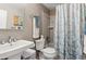 Neat bathroom featuring a sink, toilet and shower with stylish curtain at 1111 Maxwell Ave # 228, Boulder, CO 80304