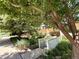 Inviting front yard with mature trees, vibrant landscaping, and a quaint white bridge at 1111 Maxwell Ave # 228, Boulder, CO 80304