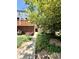 Charming townhome entrance with lush landscaping and a brick exterior facade at 1111 Maxwell Ave # 228, Boulder, CO 80304