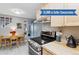 Charming kitchen featuring stainless steel appliances, light wood cabinets, and a cozy breakfast nook at 1111 Maxwell Ave # 228, Boulder, CO 80304
