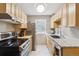 Bright kitchen features light wood cabinets, stainless steel appliances, and a window with natural light at 1111 Maxwell Ave # 228, Boulder, CO 80304
