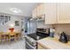 Bright eat-in kitchen with stainless steel appliances and light wood cabinets at 1111 Maxwell Ave # 228, Boulder, CO 80304