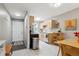 Open kitchen with stainless appliances, light wood cabinets, and adjacent dining area with door to entry at 1111 Maxwell Ave # 228, Boulder, CO 80304