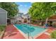 Community pool surrounded by brick patio and mature trees provides a refreshing outdoor retreat at 1111 Maxwell Ave # 228, Boulder, CO 80304