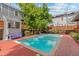 Beautiful community pool with clear blue water, surrounded by brick and lush greenery at 1111 Maxwell Ave # 228, Boulder, CO 80304