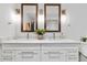 Bathroom boasts a double vanity with marble countertops, white cabinets, and matching framed mirrors with sconces at 5429 S Kearney St, Greenwood Village, CO 80111