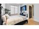 Contemporary bedroom featuring a black bed frame, a window with shade and a mounted black storage unit at 5429 S Kearney St, Greenwood Village, CO 80111