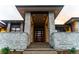 Grand entrance featuring stone accents and a striking modern front door at 5429 S Kearney St, Greenwood Village, CO 80111