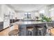 Bright kitchen featuring an expansive waterfall island with stool seating and modern cabinetry at 5429 S Kearney St, Greenwood Village, CO 80111