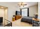 Comfortable bedroom with a ceiling fan, large window, and neutral carpet at 452 Black Feather Loop # 608, Castle Rock, CO 80104