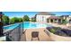 Community pool area with lounge chairs, lush landscaping, and a spacious sundeck at 452 Black Feather Loop # 608, Castle Rock, CO 80104