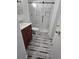 Bathroom featuring a glass shower with decorative tile and dark wood vanity at 11761 E Canal Dr, Aurora, CO 80011
