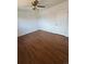 Bedroom with wood-look floors and ceiling fan with lighting at 11761 E Canal Dr, Aurora, CO 80011