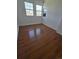 Bedroom with laminated floor, two windows and neutral paint at 11761 E Canal Dr, Aurora, CO 80011