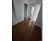 Bedroom with laminate floor, closet and doorway to bathroom at 11761 E Canal Dr, Aurora, CO 80011