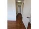 Upstairs hallway with laminate flooring and doorways to rooms at 11761 E Canal Dr, Aurora, CO 80011