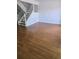 Open-concept living room with hardwood floors and a staircase at 11761 E Canal Dr, Aurora, CO 80011