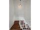 Stairway with white walls, hardwood steps and white railings at 11761 E Canal Dr, Aurora, CO 80011