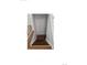 Staircase with hardwood steps, white railings, and natural light at 11761 E Canal Dr, Aurora, CO 80011