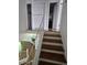 View of the staircase featuring white railings and hardwood steps at 11761 E Canal Dr, Aurora, CO 80011