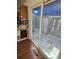 Sunroom with patterned tile flooring, sliding glass door and access to the kitchen at 11761 E Canal Dr, Aurora, CO 80011