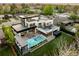 Areal view of this home with a modern pool, landscaped yard, and sleek architectural design at 140 S Glencoe St, Denver, CO 80246