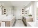 Bright bathroom featuring double vanity, makeup vanity, and large windows with natural light at 140 S Glencoe St, Denver, CO 80246