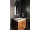 Modern powder room with a marble countertop, stylish wood vanity, and dark accent wall at 140 S Glencoe St, Denver, CO 80246
