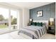Bright bedroom with a large window, wallpapered accent wall, and modern furnishings at 140 S Glencoe St, Denver, CO 80246