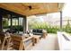 Inviting covered patio features outdoor seating and dining areas, sleek ceiling, and lush backyard view at 140 S Glencoe St, Denver, CO 80246