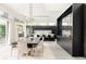 Open-concept dining room with large table, modern lighting, and wine storage, with kitchen in background at 140 S Glencoe St, Denver, CO 80246