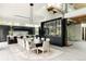 Modern dining room with view of kitchen, staircase and wine storage, showing open and connected spaces at 140 S Glencoe St, Denver, CO 80246