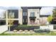 Modern two-story home boasting stone and black paneling, manicured landscaping, and a horizontal black fence at 140 S Glencoe St, Denver, CO 80246