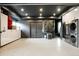 Spacious garage with ample storage, including a refrigerator, washer, and dryer at 140 S Glencoe St, Denver, CO 80246