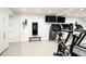 Well-equipped home gym with mirrored wall, treadmill, and weight training equipment at 140 S Glencoe St, Denver, CO 80246