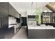 Modern kitchen featuring sleek dark cabinetry, marble countertops and a wine storage feature at 140 S Glencoe St, Denver, CO 80246