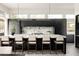 Modern kitchen featuring a marble backsplash, waterfall island, and sleek cabinetry, bathed in natural light at 140 S Glencoe St, Denver, CO 80246