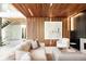 Stylish living room featuring a striking wood ceiling, modern artwork, and a cozy seating area with fireplace at 140 S Glencoe St, Denver, CO 80246