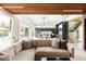 Open-concept living room showcasing a modern design, elegant staircase, chef's kitchen, and access to backyard pool at 140 S Glencoe St, Denver, CO 80246